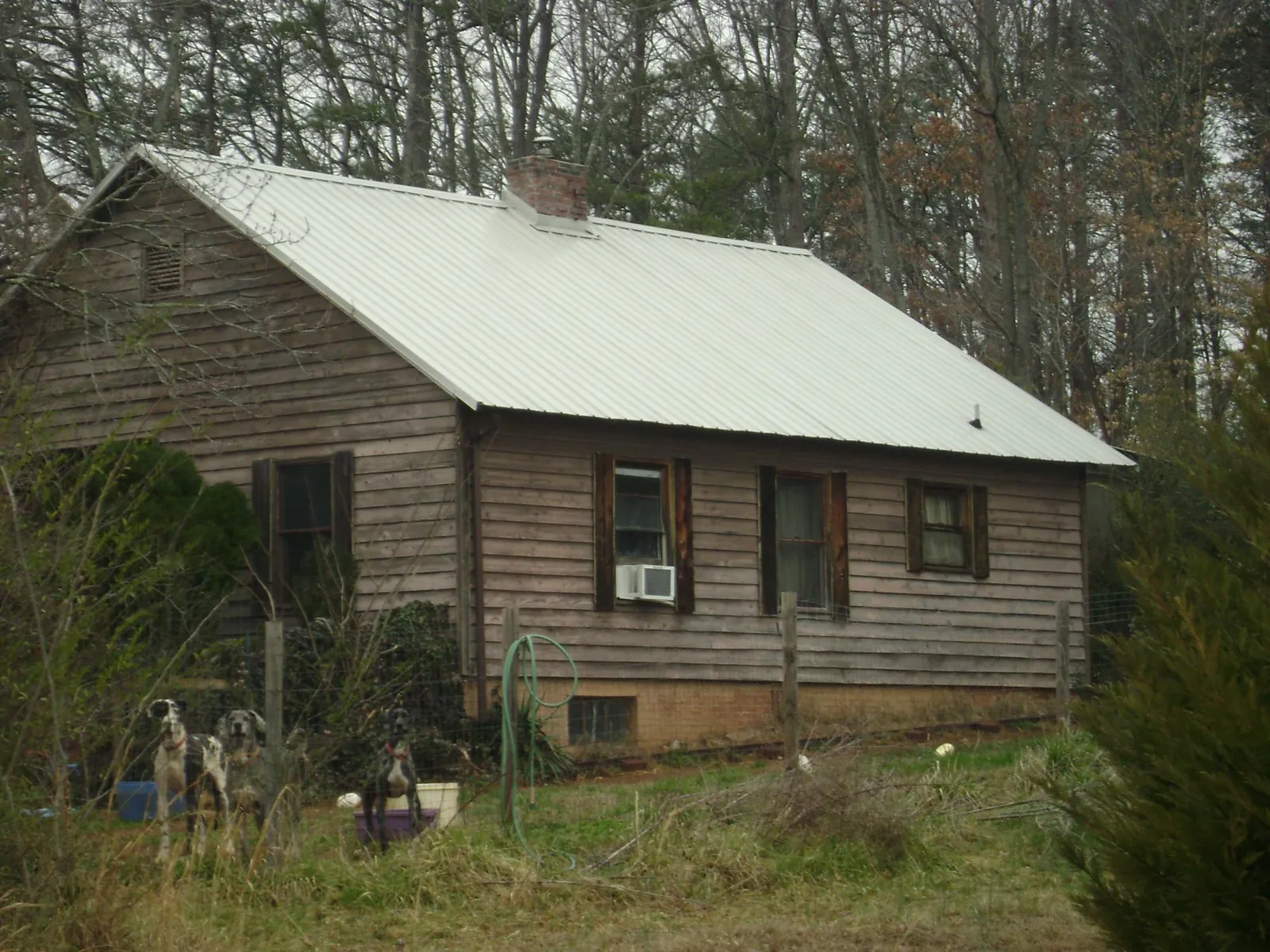 White metal roof on an old wood sided farmhouse, from a Metal Roof Installation job in East Bernard